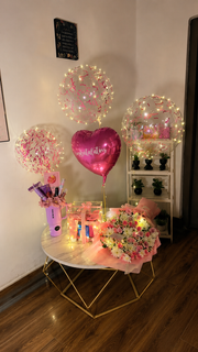 congratulations balloon decor with flower bouquet,gift box and birthday cake on a table 