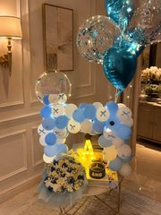Azure Elegance blue and white birthday balloon setup with flowers