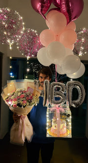 Premium floral birthday celebration box with fresh flower bouquet, LED acrylic cake box, HBD balloons, and pink heart balloons