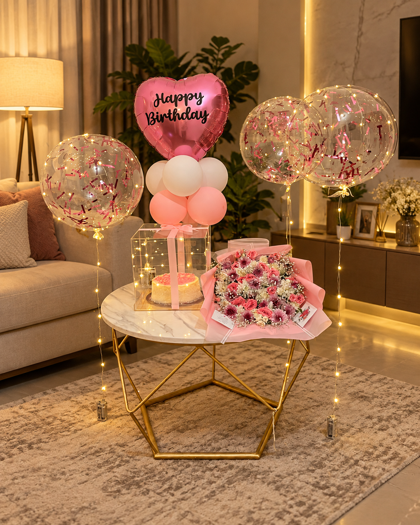 Pink Fantasy Affair birthday setup with pink balloons, cake, floral bouquet and luxury celebration decorations