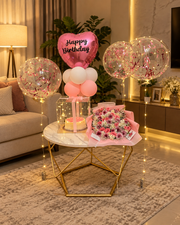 Pink Fantasy Affair birthday setup with pink balloons, cake, floral bouquet and luxury celebration decorations