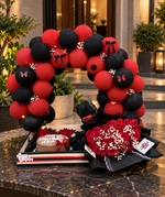 Load image into Gallery viewer, Elegant Crimson Noir birthday surprise with red flowers and decorative balloon arch