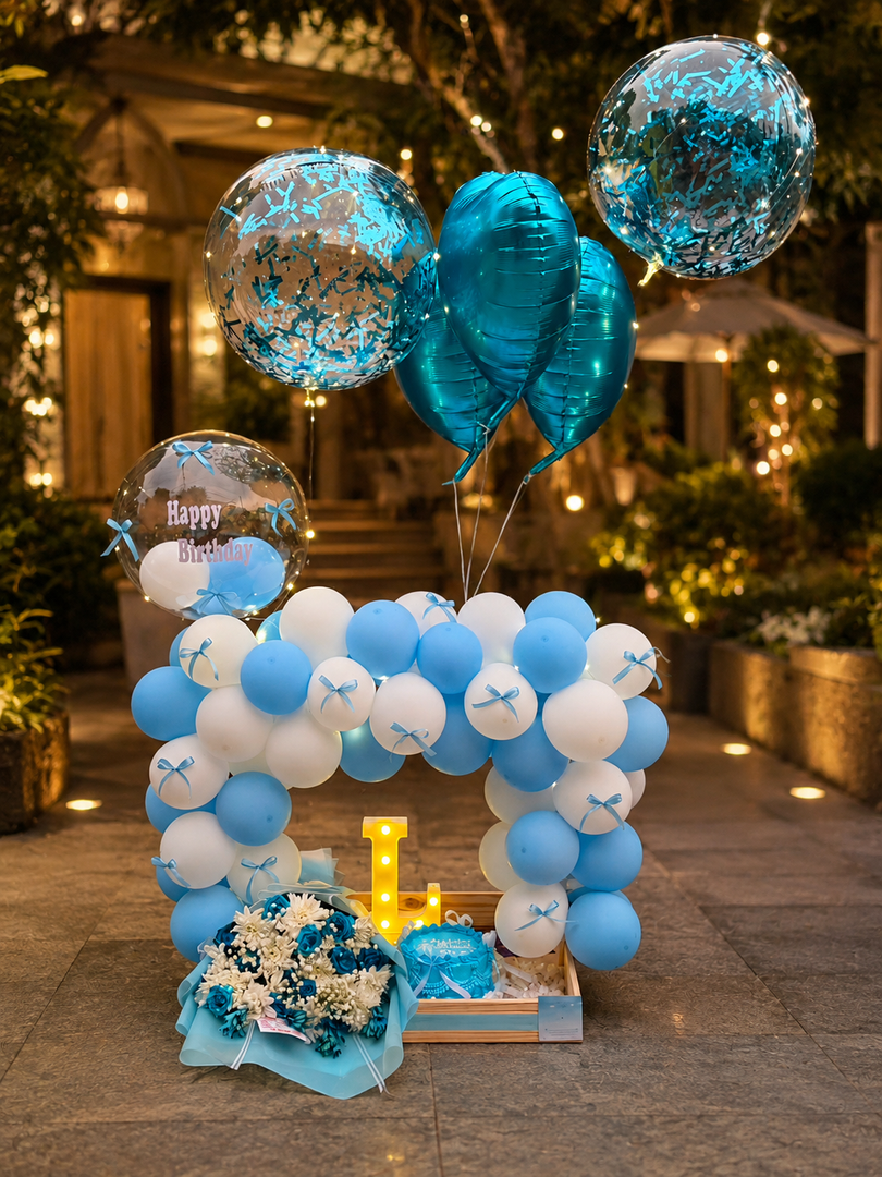 Sapphire Bloom blue and white birthday balloon arch with floral bouquet and gift box