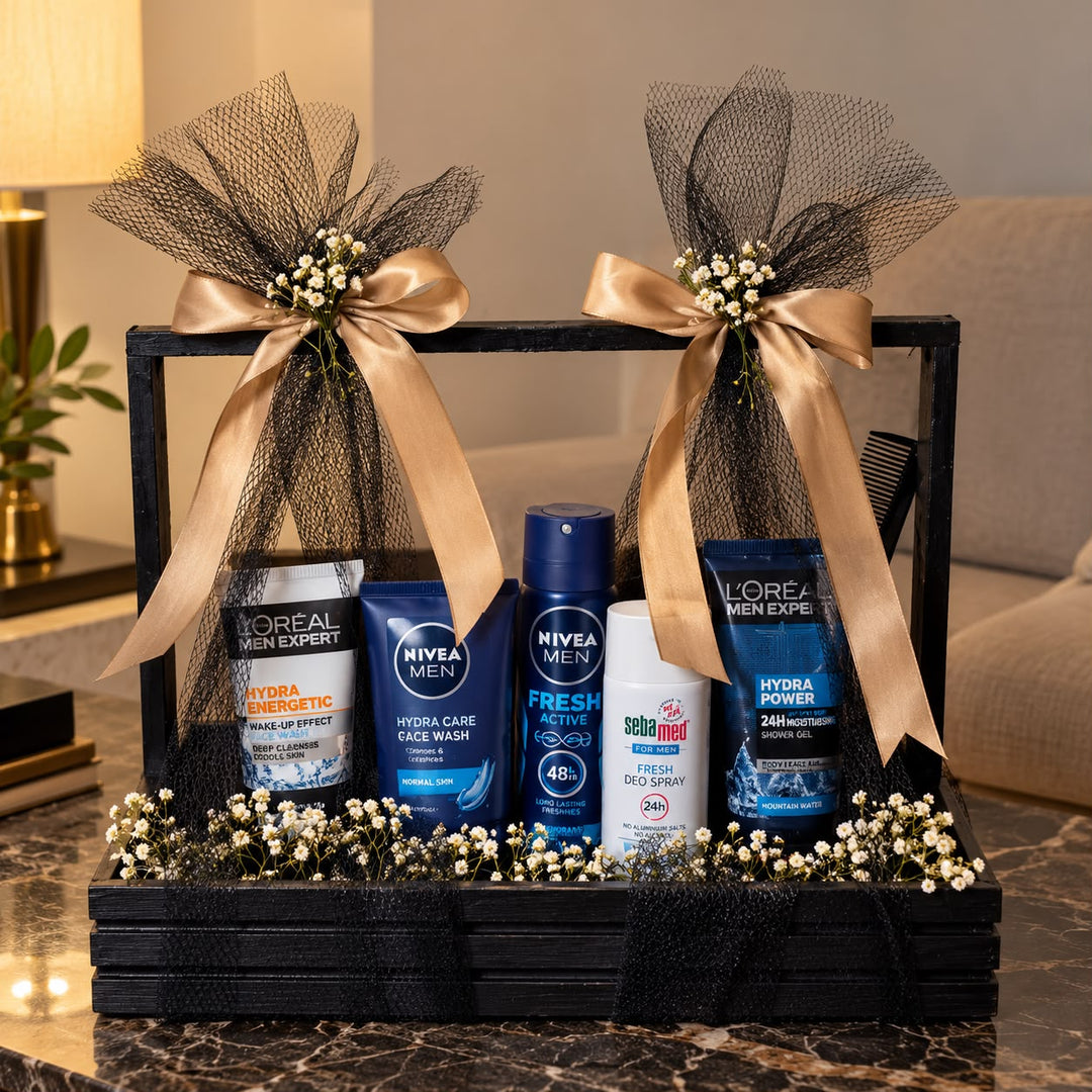 Men's grooming gift hamper with Nivea, L'Oréal Men Expert and Sebamed skincare products in a black wooden crate with golden ribbons.