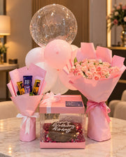 Blush Serenity pink gift arrangement with roses, balloons, chocolates and birthday cake