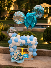 Sapphire Bloom birthday setup with blue white balloons, flowers and gift box