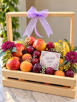 Load image into Gallery viewer, Fresh Wishes get-well-soon fruit basket with red apples, bananas, plums, citrus fruits, purple flowers, lavender bow, and wooden crate.