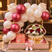 Pearl Blossom pink and white balloon setup with butterfly cake and floral arrangement