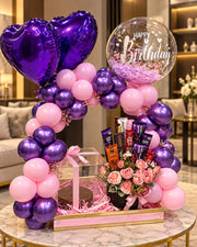 Orchid Moonlight luxury birthday gift arrangement with violet balloon arch, roses, chocolates and elegant gift box