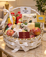 Load image into Gallery viewer, Get-well-soon gift hamper in a white woven basket with fruit drinks, fresh apples, biscuits, satin ribbons, and greeting cards.