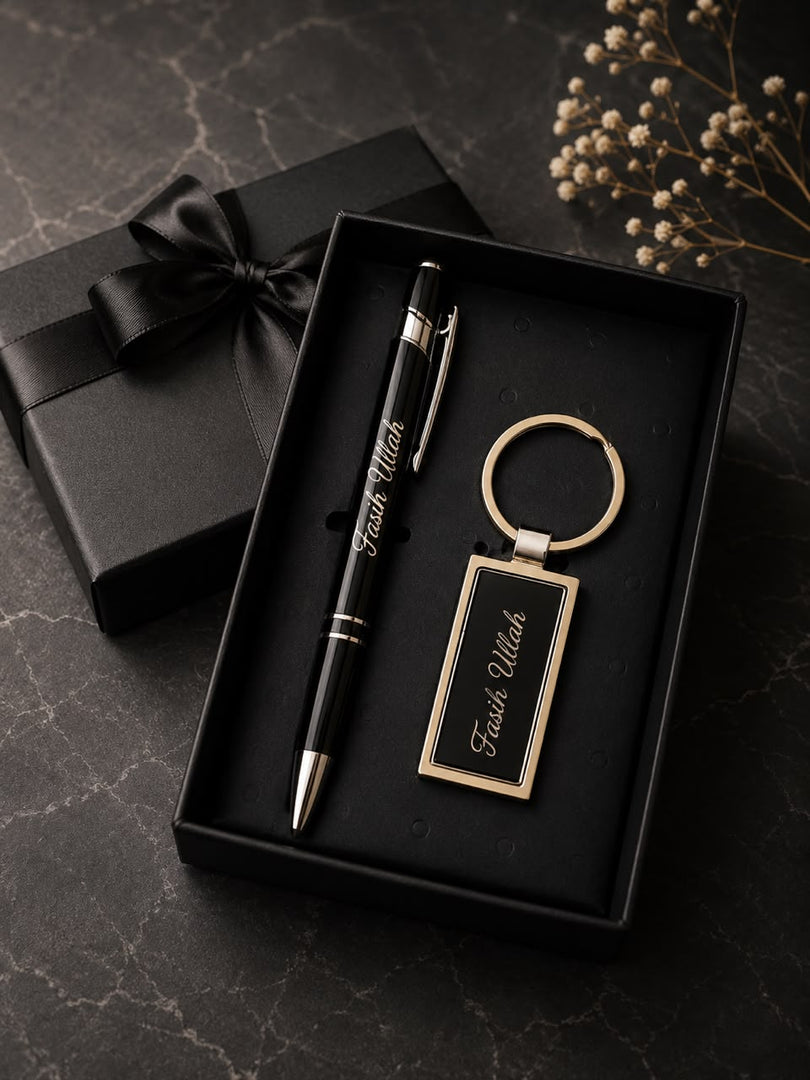 Personalized black and gold pen and keychain set engraved with name, presented in black gift box with satin bow