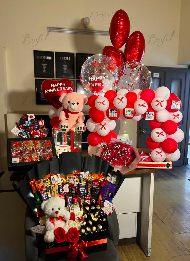 Luxury anniversary gift box with roses, chocolates, teddy bears, personalized gifts, and elegant anniversary balloon setup in Pakistan