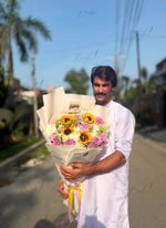 Load image into Gallery viewer, Fresh sunflower and mixed flower bouquet wrapped in white paper with a gold balloon for birthday celebrations and special occasions