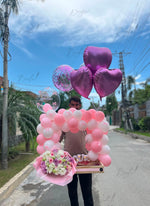 Load image into Gallery viewer, Petaline Haven luxury gift arrangement featuring a pink and white balloon arch, heart-shaped helium balloons, fresh flower bouquet, and premium cake.