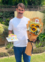 Fresh yellow sunflower bouquet paired with birthday cake