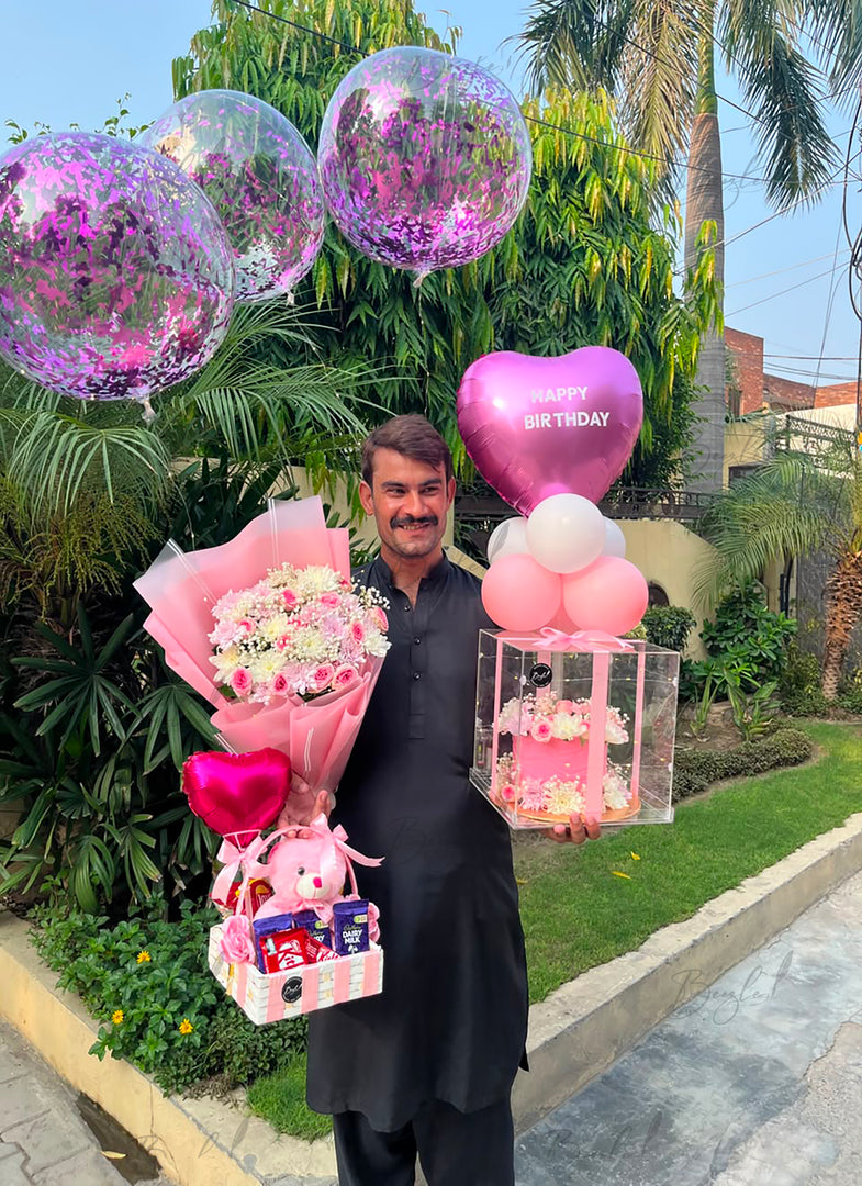 Pink birthday gift arrangement with flower bouquet, teddy bear and heart balloon