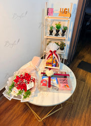 Red rose bouquet with assorted snacks and chocolates in a gift arrangement