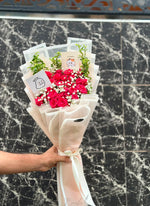 Load image into Gallery viewer, Close-up of fresh red roses with delicate white flowers in a wrapped bouquet