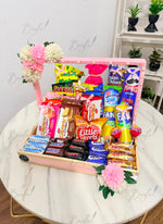Load image into Gallery viewer, Colorful snack and chocolate gift basket with pink and white flowers