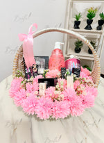 Load image into Gallery viewer, Pink flower gift basket with beauty and self-care products