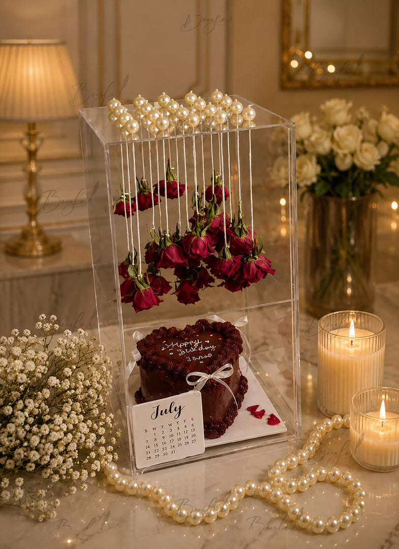 Rose Elegance Memory Box with floating red roses, chocolate cake, pearl decorations, and luxury acrylic gift display.