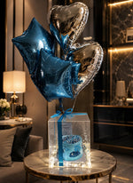 Load image into Gallery viewer, Celestial Royal Box with blue birthday cake, metallic star and heart balloons, fairy lights, and elegant acrylic luxury gift packaging.