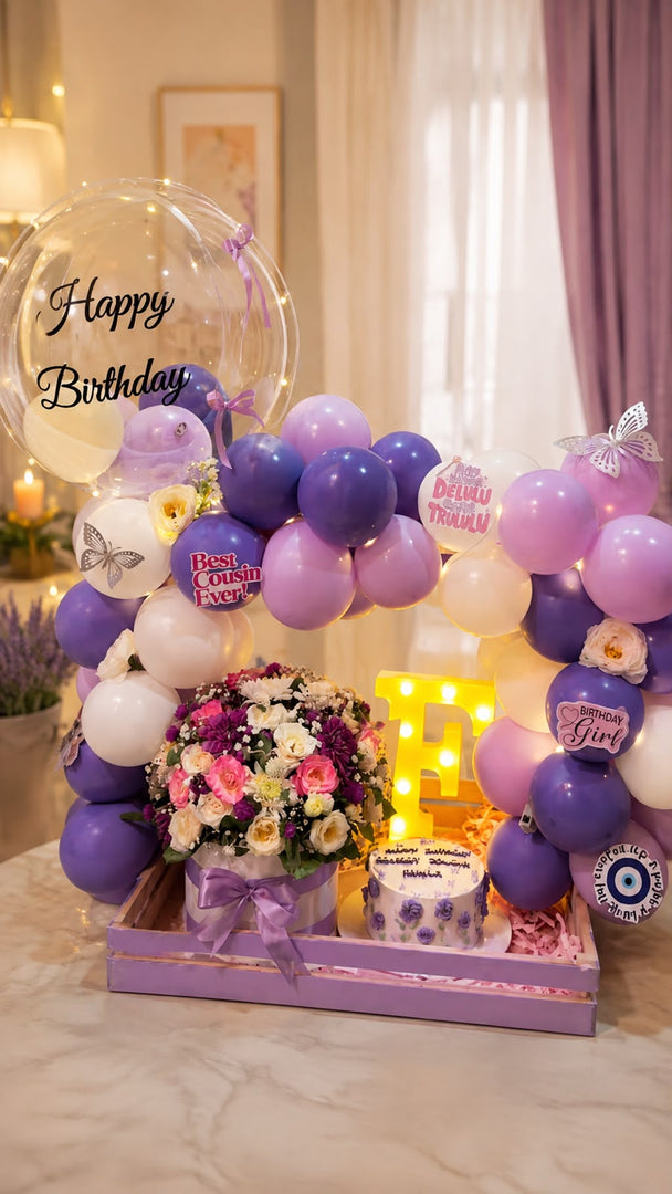 Lavender Dreamscape luxury birthday setup with purple balloons, floral arrangement, cake, and personalized bubble balloon.