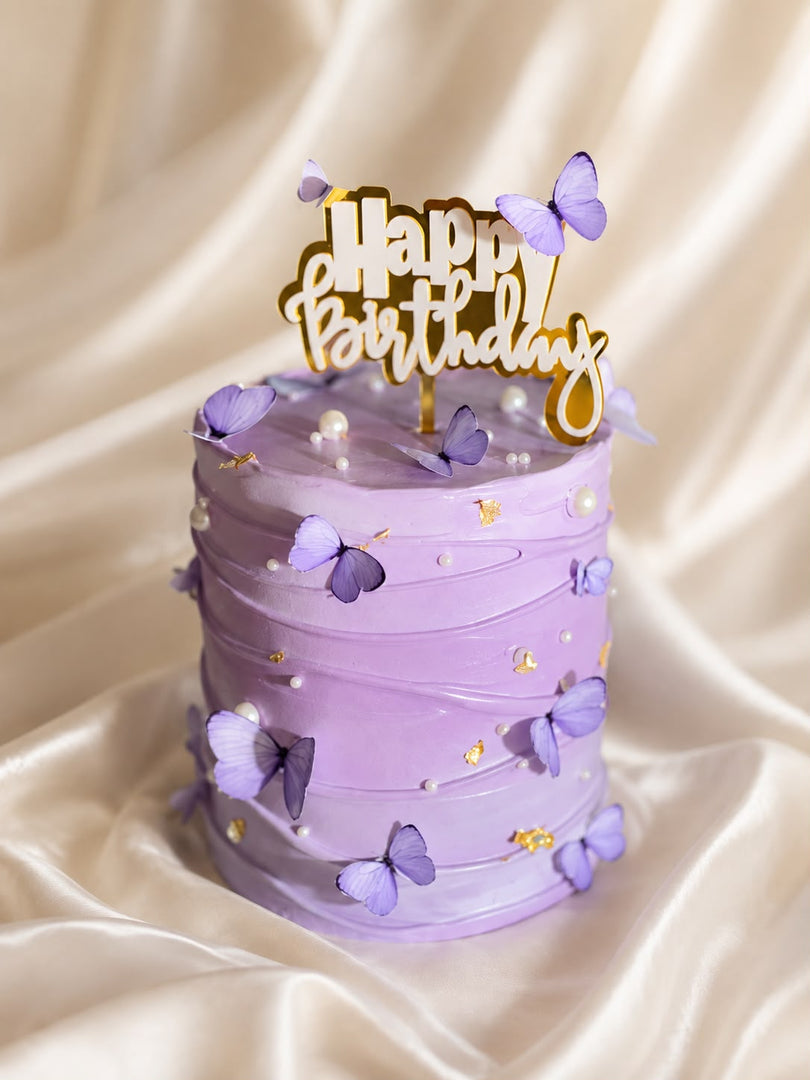 Lavender Reverie birthday cake with purple butterflies, pearls and gold accents