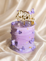 Lavender Reverie birthday cake with purple butterflies, pearls and gold accents