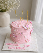 Pink butterfly birthday cake with pearl accents and personalized lettering