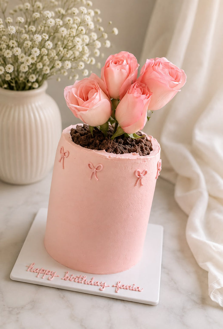Rose Petal Cake with blush pink buttercream, fresh pink roses, bow details, and personalized birthday message on a white cake board