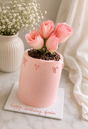 Rose Petal Cake with blush pink buttercream, fresh pink roses, bow details, and personalized birthday message on a white cake board