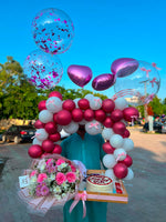 Load image into Gallery viewer, Magenta and white balloon arch with pink flower bouquet, birthday cake, heart balloons, and gift tray
