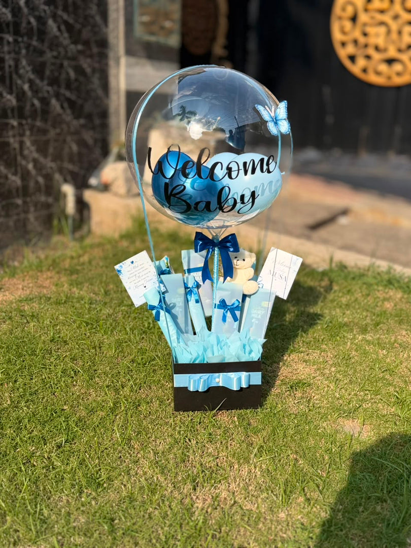 Little Blue Joy newborn gift hamper with Welcome Baby balloon, teddy bear and blue baby essentials