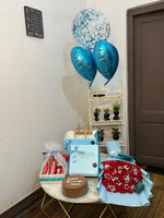 Load image into Gallery viewer, Ruby Birthday Luxe with red rose bouquet, chocolate cake, gift box, snack basket and blue balloons