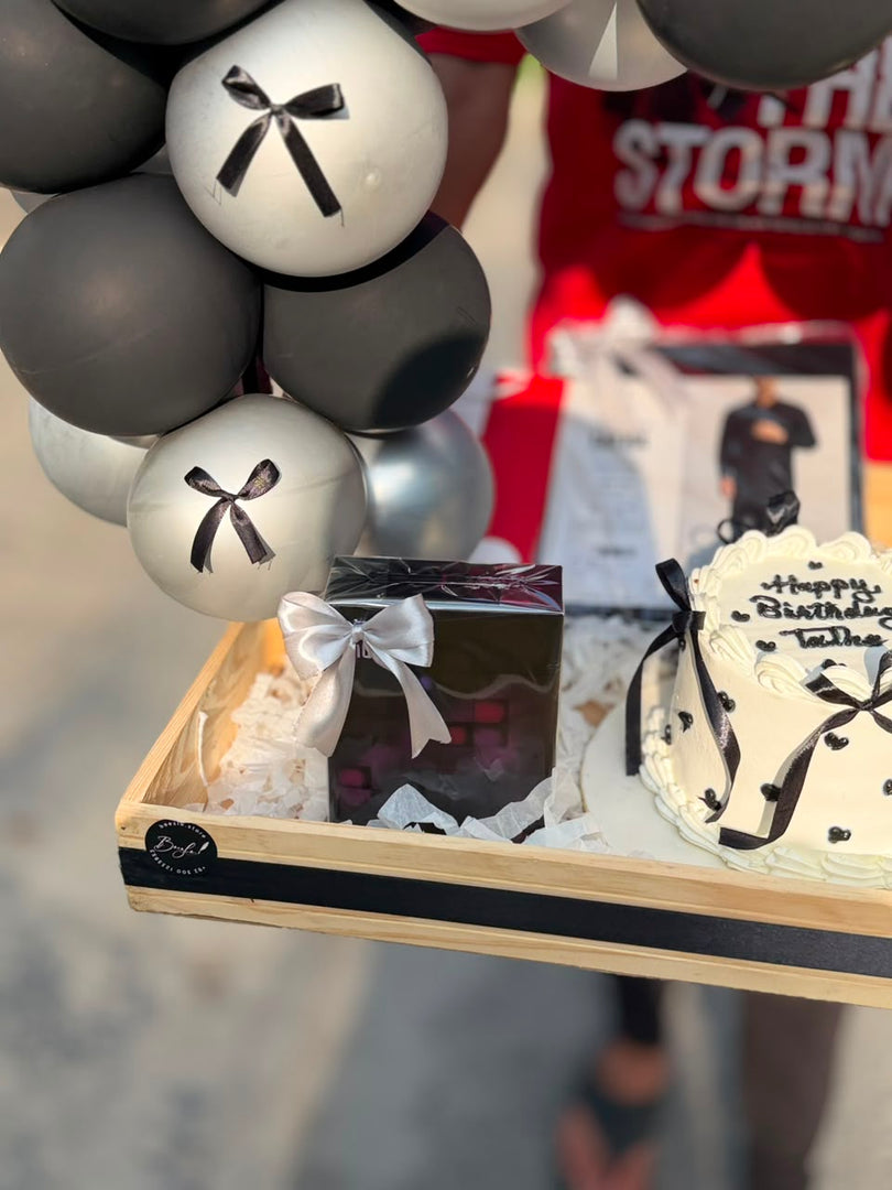 Birthday gift box with wrapped fashion item and accessories