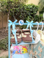 Load image into Gallery viewer, Close-up of blue and white baby gift hamper with clothes and newborn essentials