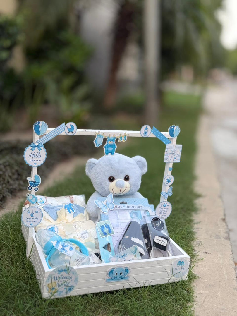 Blue newborn baby boy gift basket with teddy bear and baby care items