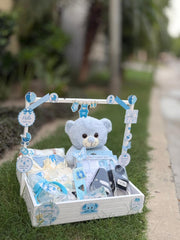 Blue newborn baby boy gift basket with teddy bear and baby care items