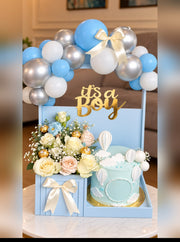 Baby blue It’s a Boy gift set with balloon garland, pastel roses and a hot air balloon cake