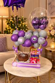Purple and silver balloon birthday hamper with chocolate cake, snack treats and decorative ribbons