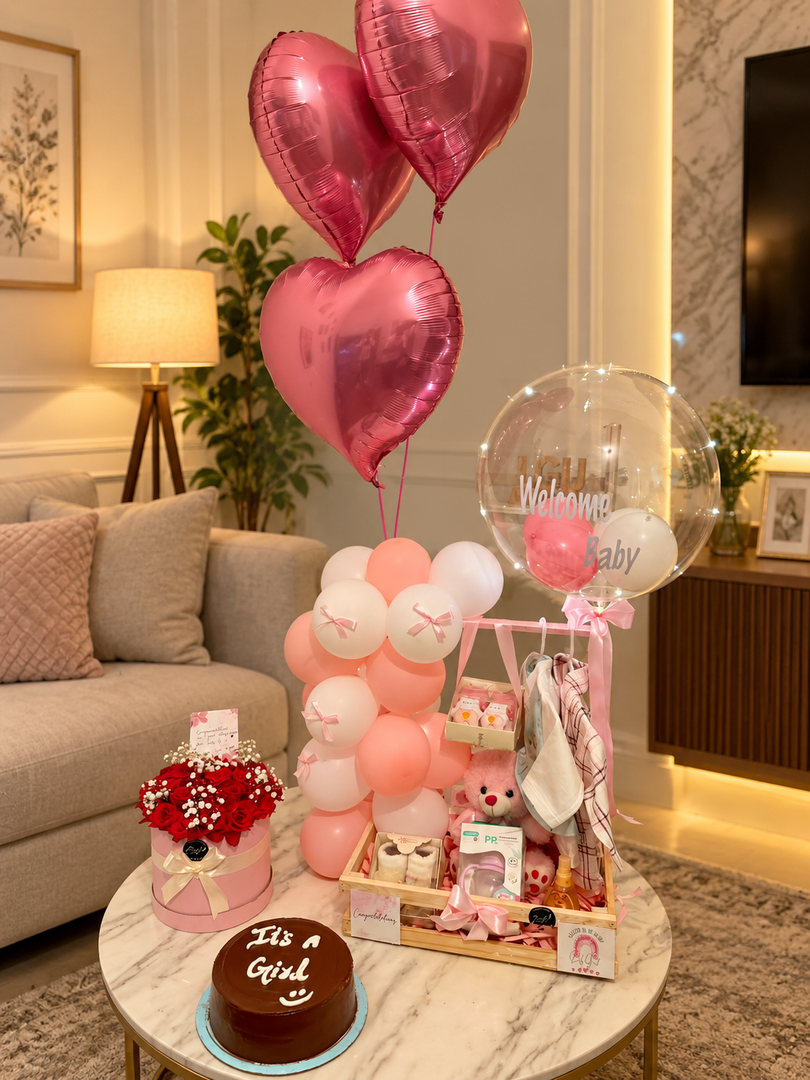 Newborn baby girl gift hamper with pink balloons, baby clothes, teddy bear and welcome baby balloon