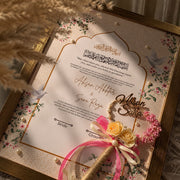 Personalised floral Nikah certificate with pink flowers, Arabic calligraphy, gold frame, pearl embellishments, and matching rose-decorated Nikah pen.