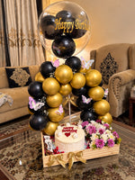 Load image into Gallery viewer, Golden Moments luxury birthday gift with black gold balloons, butterfly decorations, flowers and celebration cake