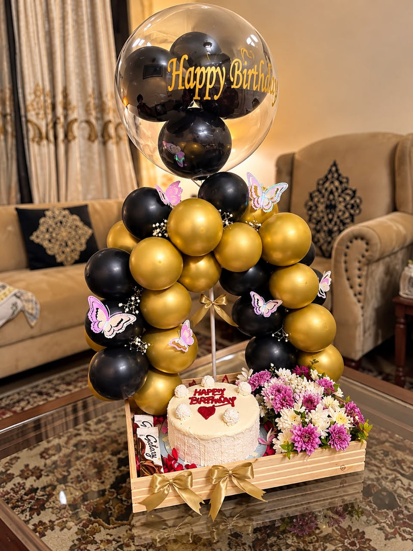 Golden Moments luxury birthday gift with black gold balloons, butterfly decorations, flowers and celebration cake