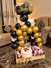 Golden Moments luxury birthday gift with black gold balloons, butterfly decorations, flowers and celebration cake
