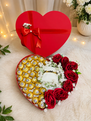 Crimson Embrace heart-shaped gift box with red roses, chocolates, and white floral accents.