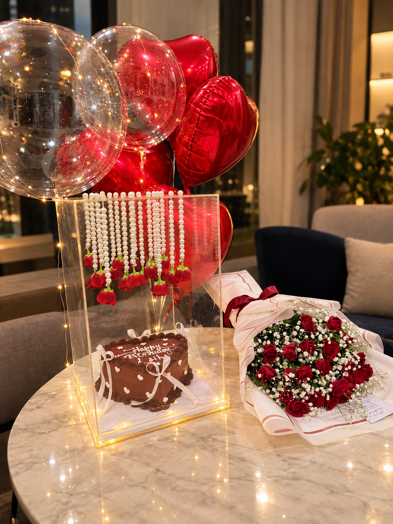 Scarlet Pearl birthday surprise with red roses, heart balloons, chocolate cake and pearl rose backdrop