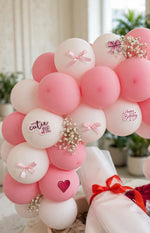 Load image into Gallery viewer, Close-up of pink and white balloons decorated with satin bows, butterfly and heart accents, birthday stickers, and tiny white flowers.