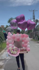 Load and play video in Gallery viewer, Premium Petaline Haven gift setup with pastel balloons, fresh floral bouquet, customized bubble balloon, and celebration cake in Pakistan.